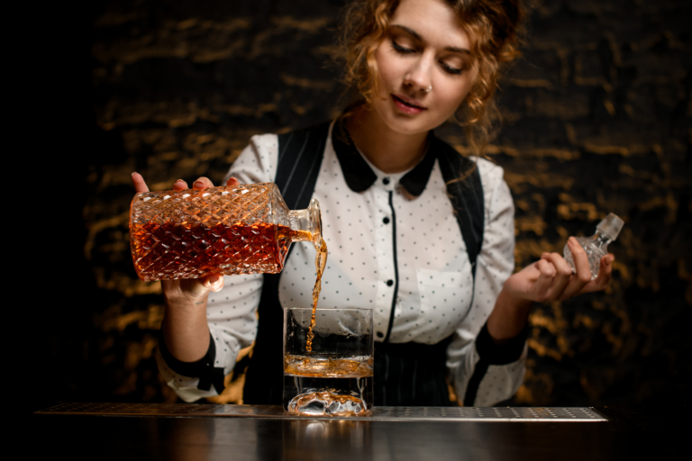 Woman pouring whisky for tasting event denver